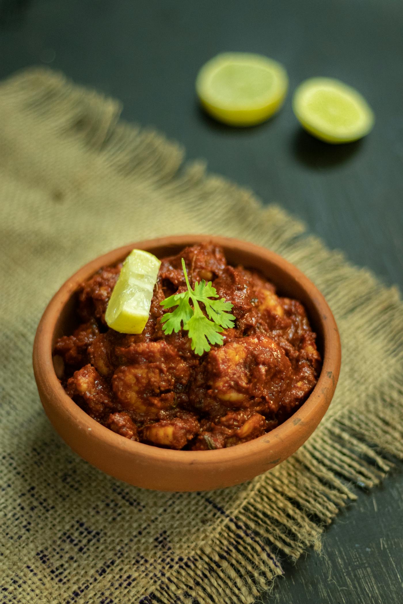 Mangalorean chicken ghee roast — dark, glossy masala in a terracotta bowl